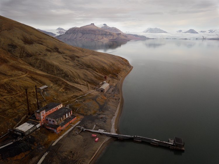 78.656826ºN, 16.390980ºE
Aerial shot of Pyramiden's coal-fired power station with the surging Nordenskiöldbreen glacier in the distance.  Svalbard, Arctic Norway.